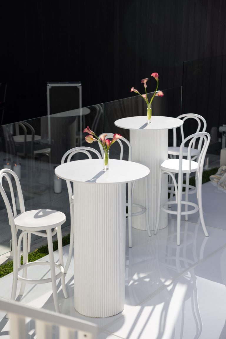 White bar tables and white bentwood bar stools