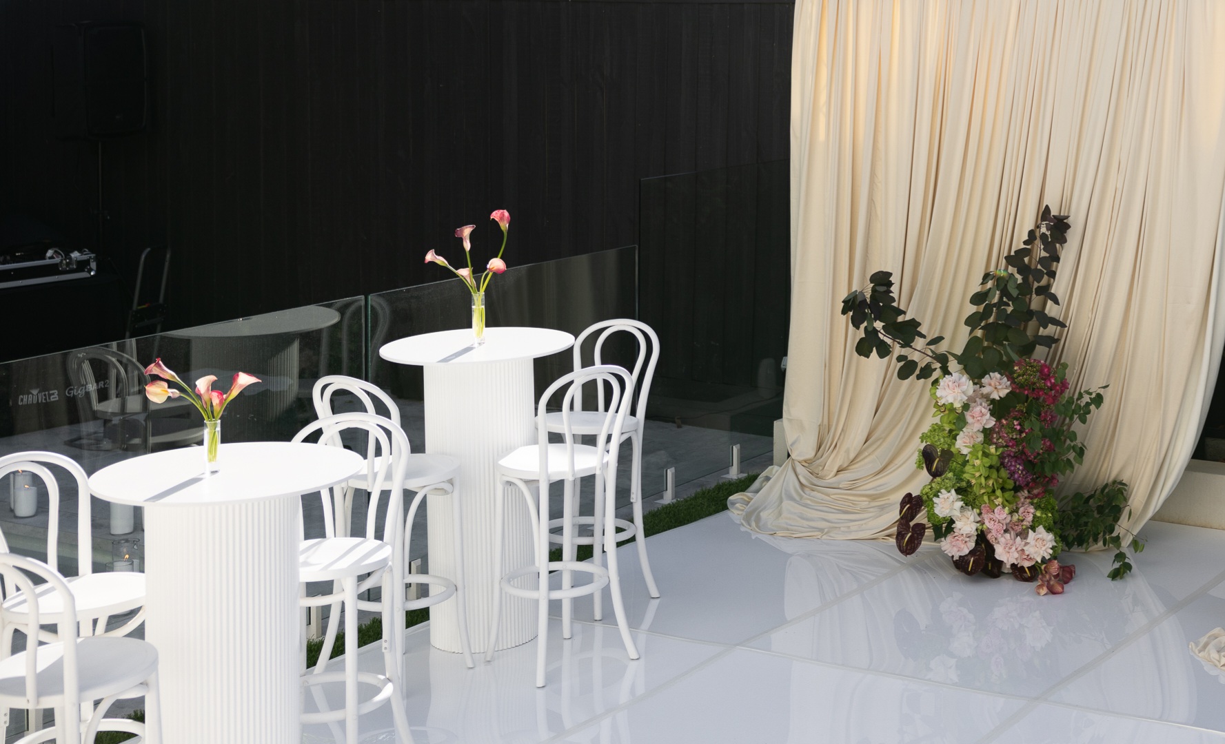 White bar table and bentwood bar stools on white dance floor