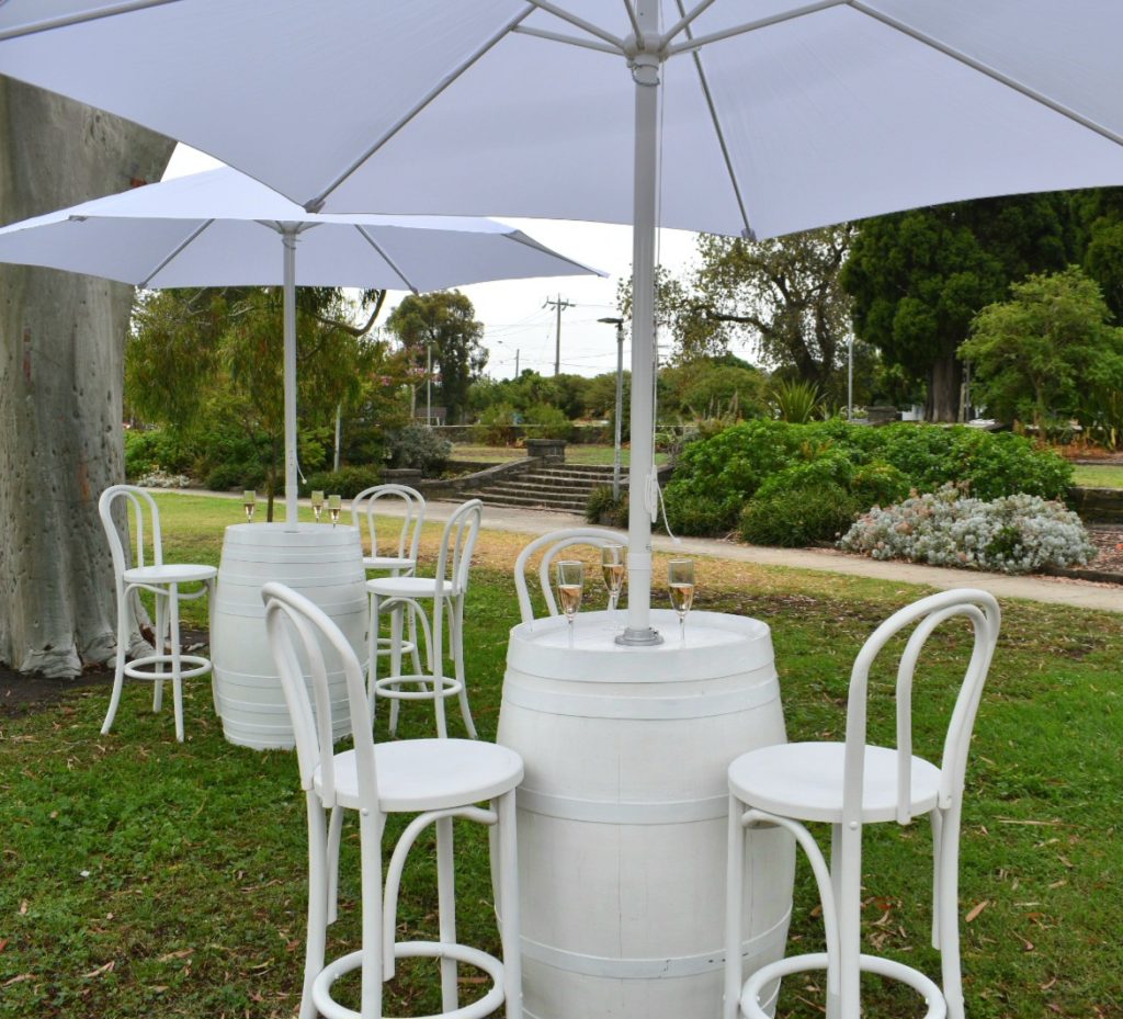 White wine barrel with umbrella and bentwood stools