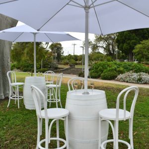White wine barrel with umbrella and bentwood stools